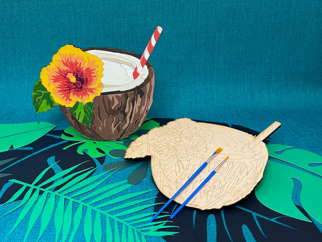 The Pina Colada Paint by Number design features a coconut shell cup, with a bright hibiscus flower and a classic red and white striped straw