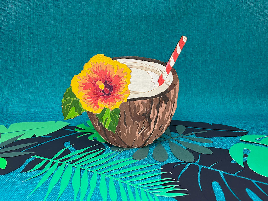 Tiki Lovers UNITE! The new Tiki Time Paint by Numbers collection features four beautiful drinks. The Pina Colada paint by number keeps it classy by using all parts of the coconut! The drink is held in a coconut shell, with that beautiful brown husk adding detail to the cup. On the left rim a colorful red, orange, and red hibiscus flower.