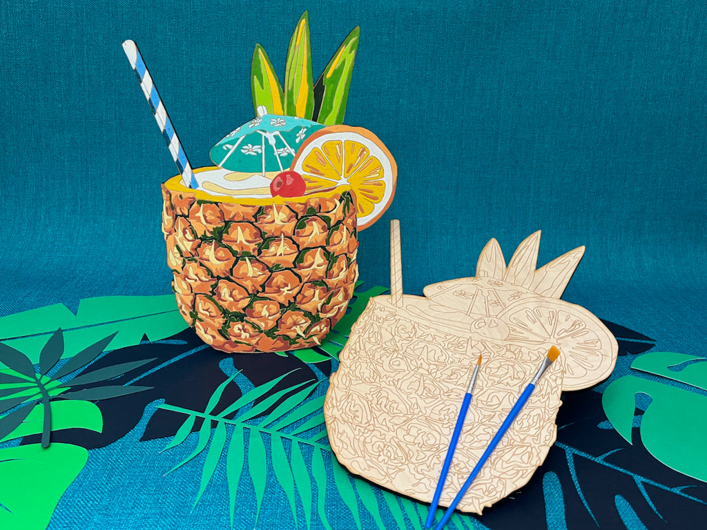 The Painkiller paint by number design features a pineapple turned mug with a very ornate garnish of Pineapple leaves, an orange slice, and a cherry speared by a teal paper tiki umbrella. Oh, and don't forget the blue and white striped paper straw!